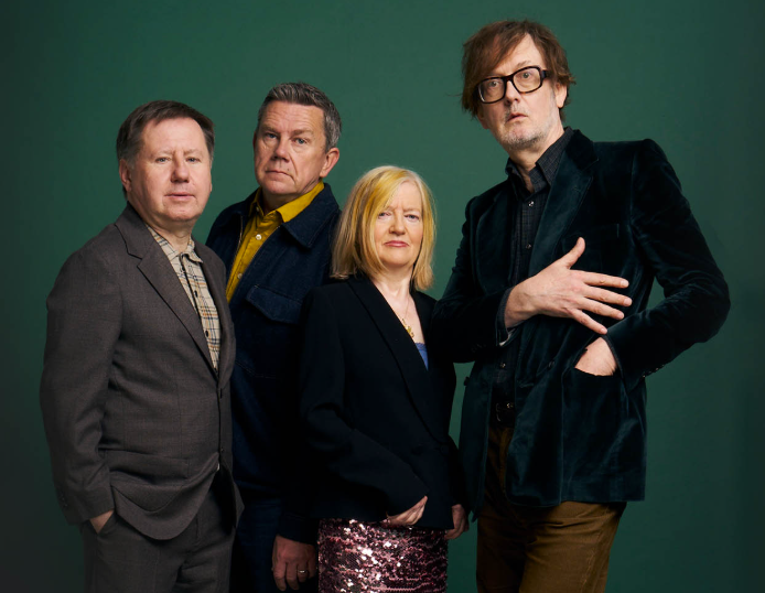 Pulp in later years — four members including Jarvis Cocker in a velvet jacket and glasses