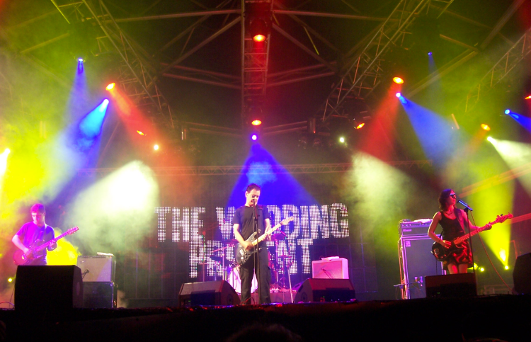 The Wedding Present performing beneath coloured stage lights