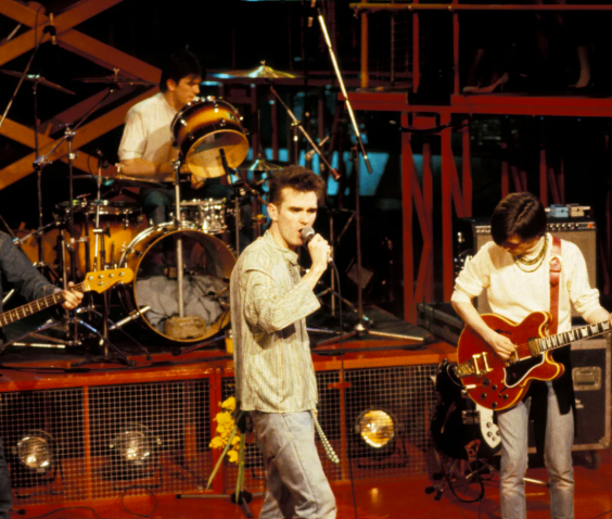 The Smiths performing live, with Morrissey at the microphone and Johnny Marr playing guitar
