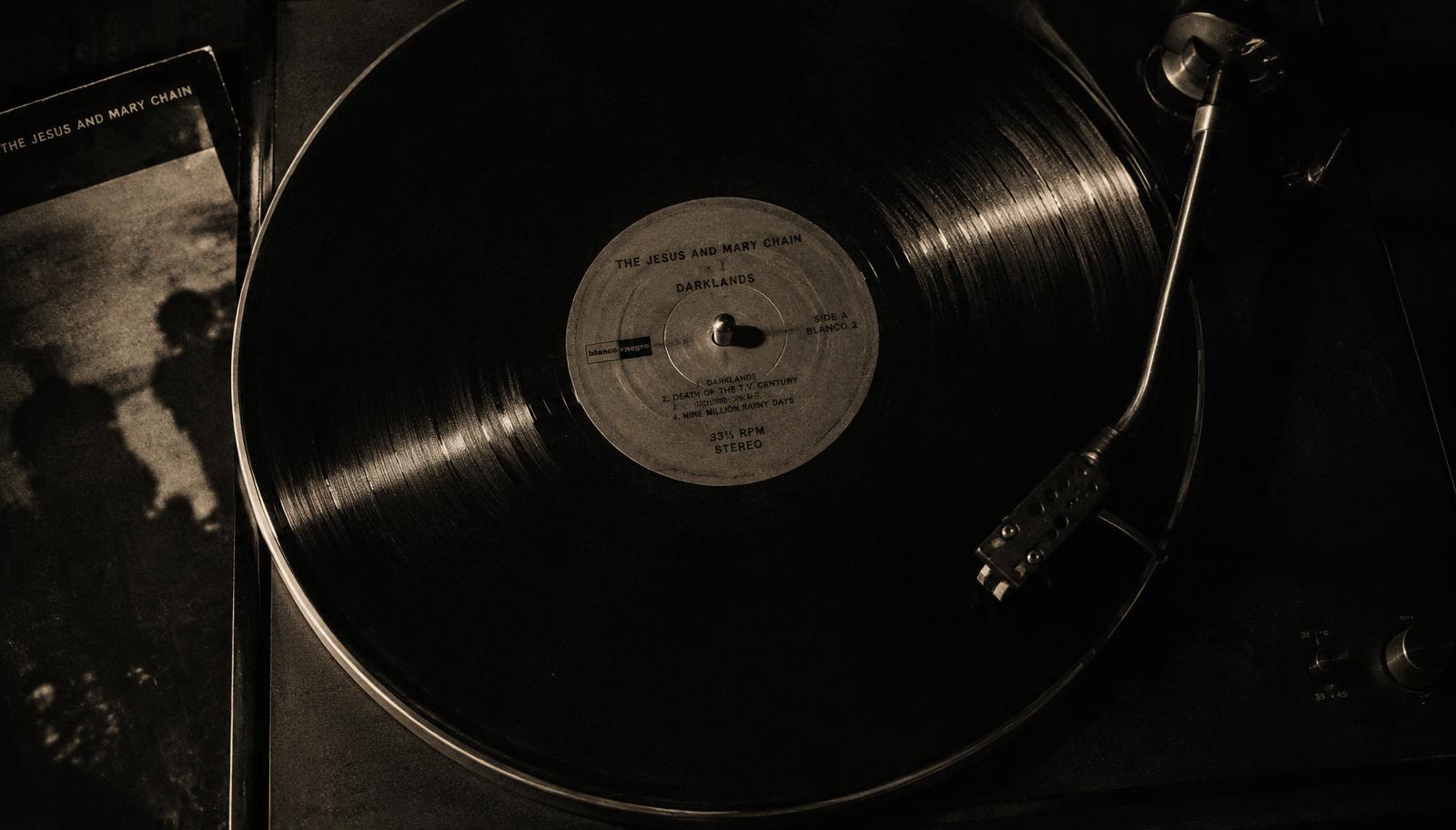A vinyl record catching the light — placeholder imagery